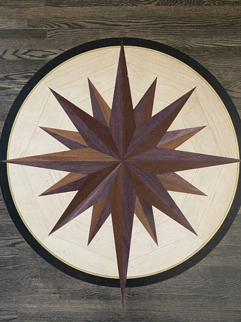 Wooden compass rose on circular floor design.