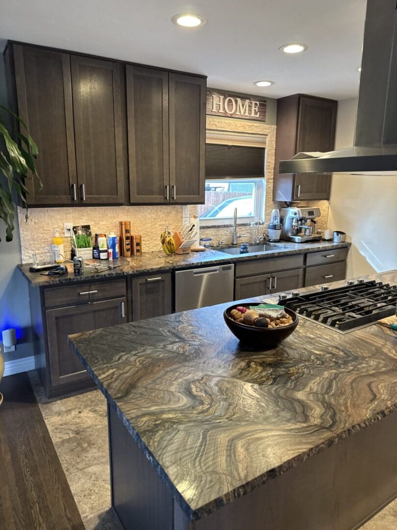 Modern kitchen with dark cabinets and island.