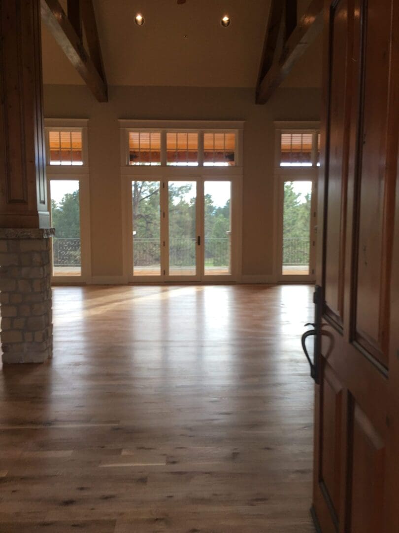 Spacious room with large windows and door.