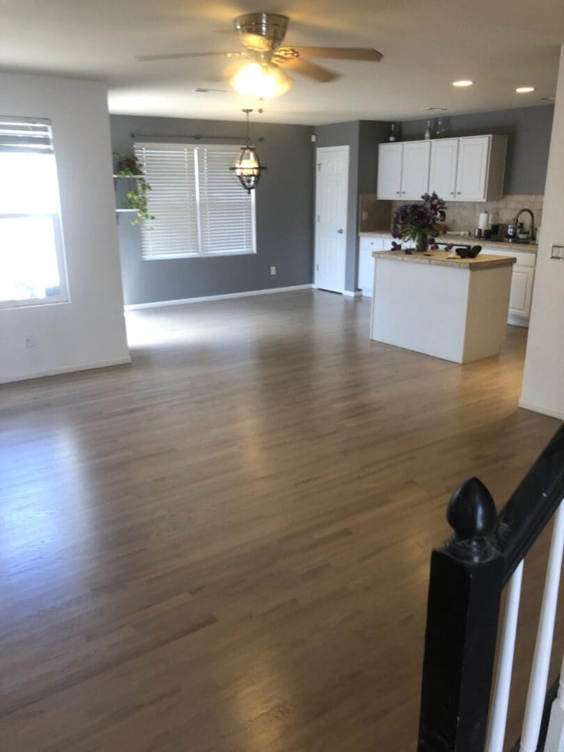 Open kitchen and living area with light flooring.